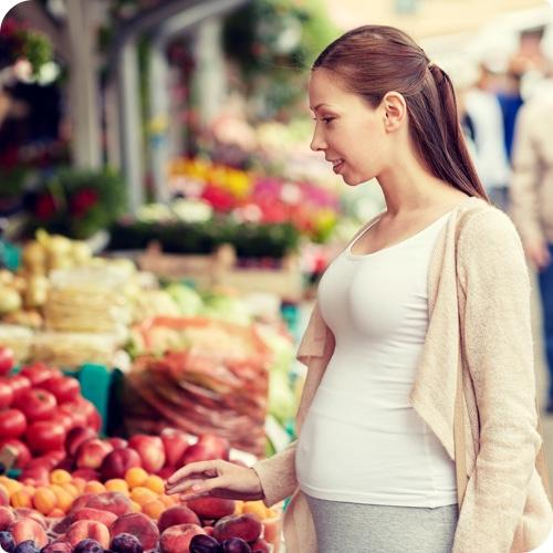 Woman browsing fruit at market